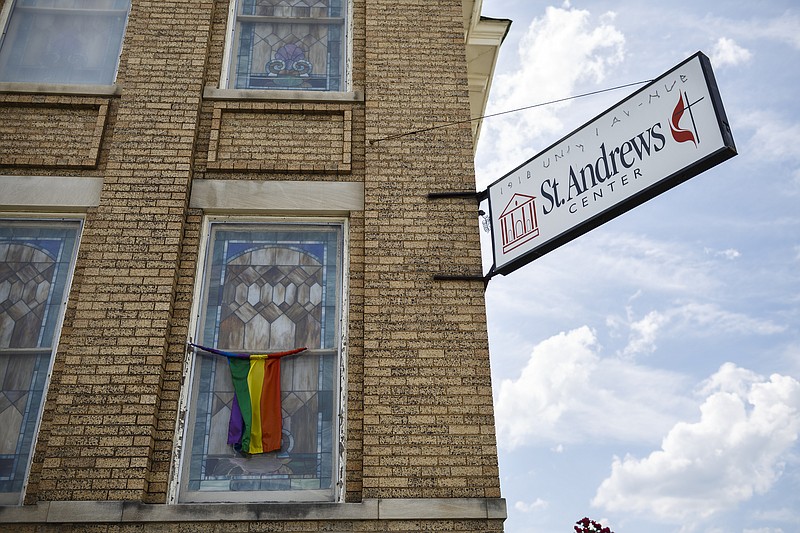 A rainbow flag hangs on an exterior window of Mercy Junction Justice and Peace center in Highland Park on Wednesday, May 17, 2017, in Chattanooga, Tenn. The center has been forced to close temporarily after safety concerns were raised about two residents who have formed their own religion.