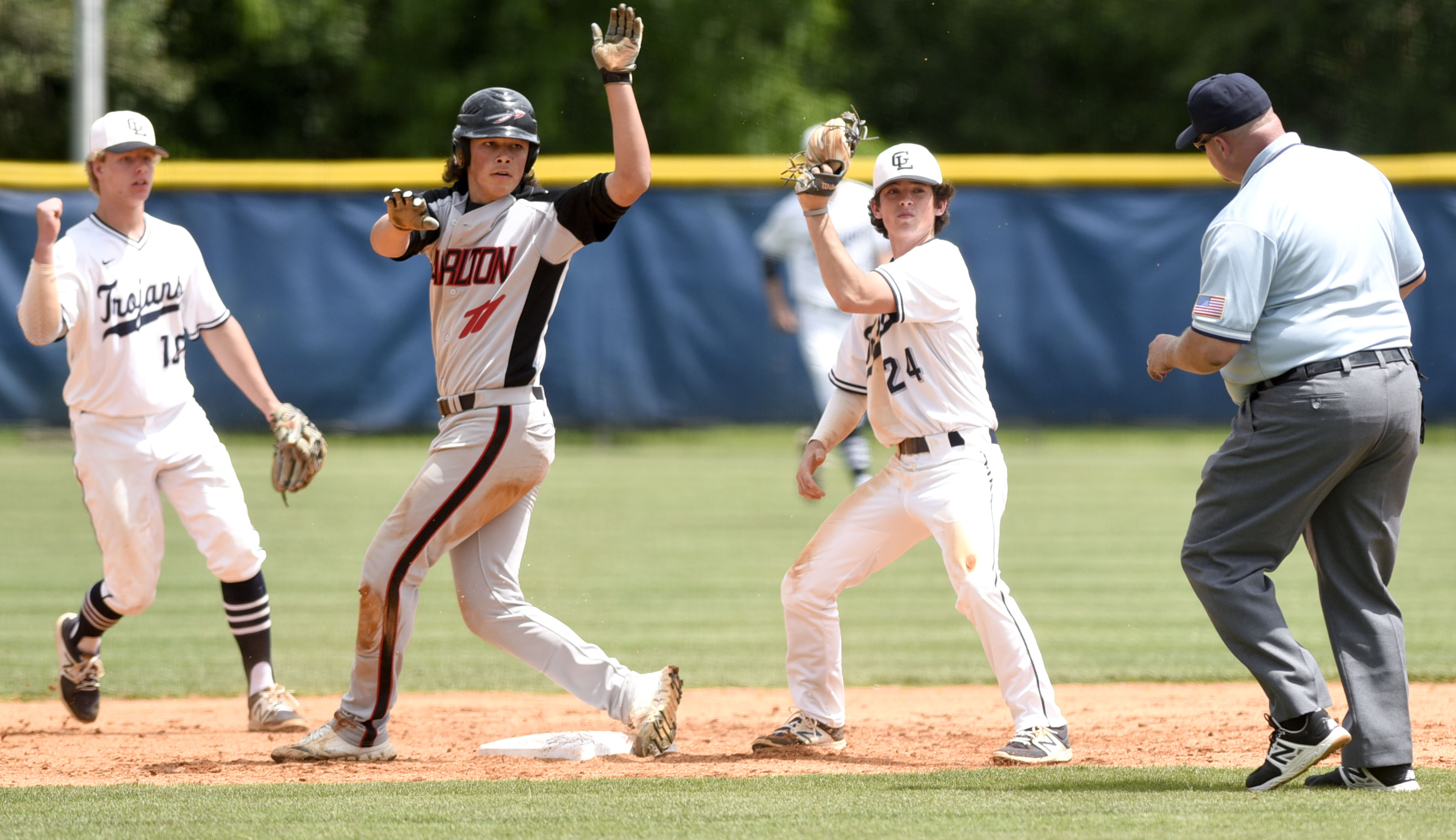 Gordon Lee 2nd baseman Kobie Cowan (24) displays he still has the ball while the umpire calls Charlton County's Austin Knowles (11) out trying to steal. Gordon Lee shortop Moah Peterson aids the umpire's call. The Charlton County Indians visited the Gordon Lee Trojans in the Georgia State Baseball Tournament Semifinals on May 17, 2017.