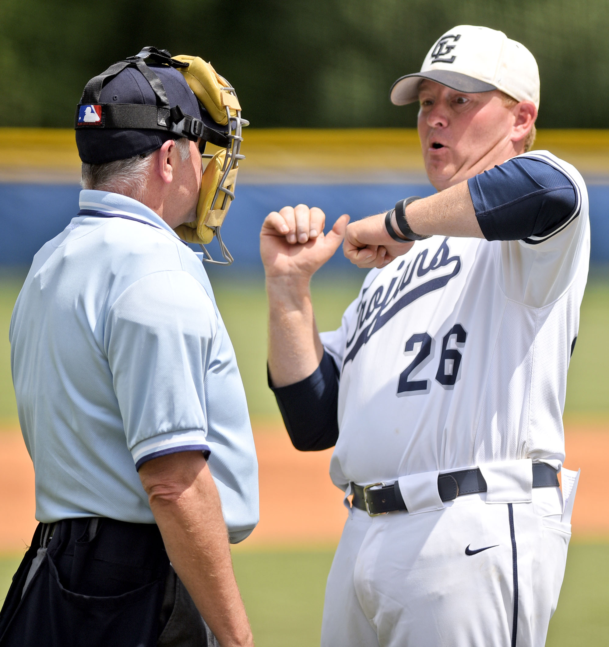 Gordon Lee head coach Mike Dunfee argues the plate umpire's call of a hit batter. The Charlton County Indians and the Gordon Lee Trojans split a state semifinal doubleheader Wednesday in Chickamauga, Ga. and play a deciding game today.