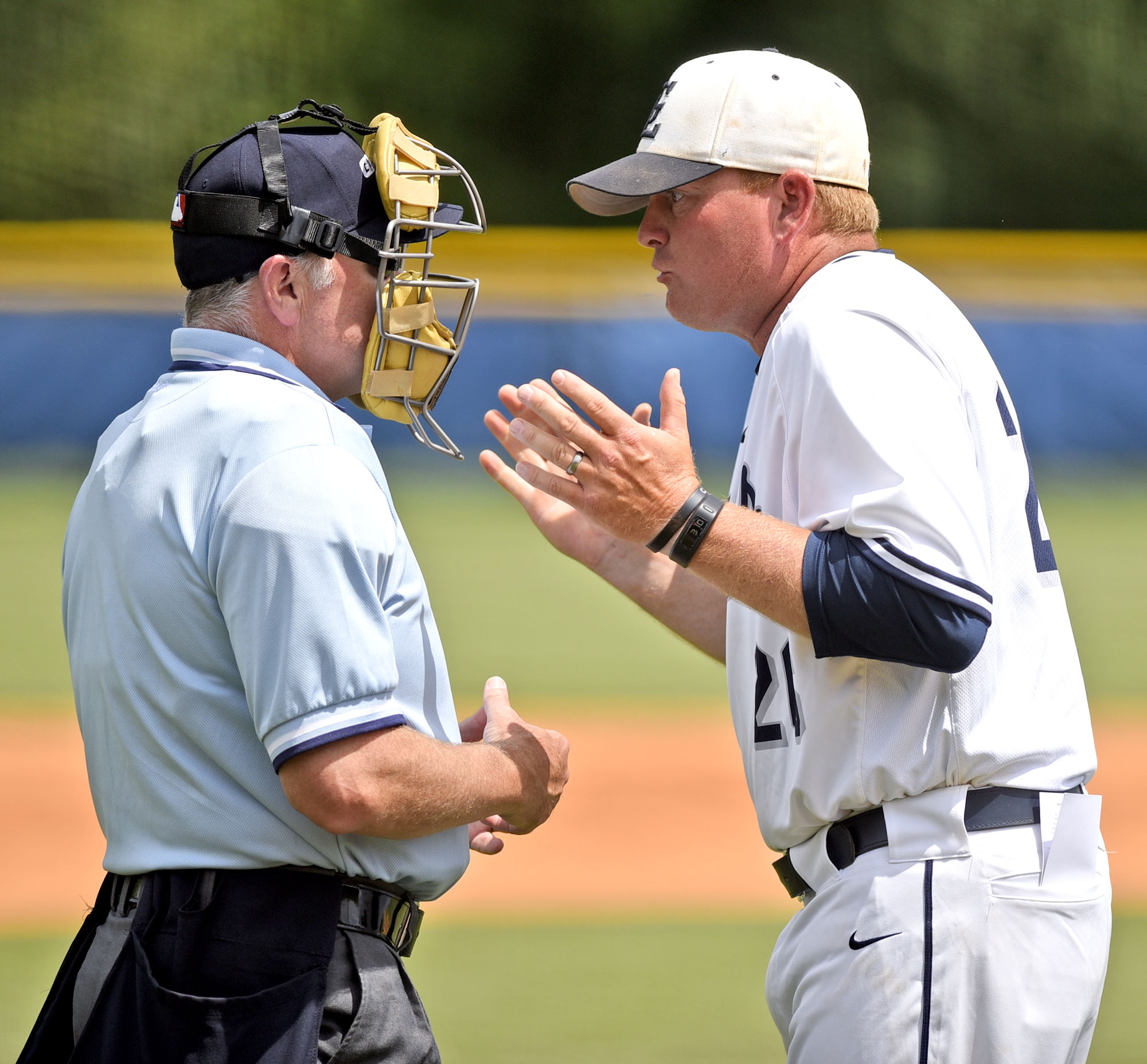 Gordon Lee head coach Mike Dunfee argues the plate umpire's call of a hit batter. The Charlton County Indians and the Gordon Lee Trojans split a state semifinal doubleheader Wednesday in Chickamauga, Ga. and play a deciding game today.