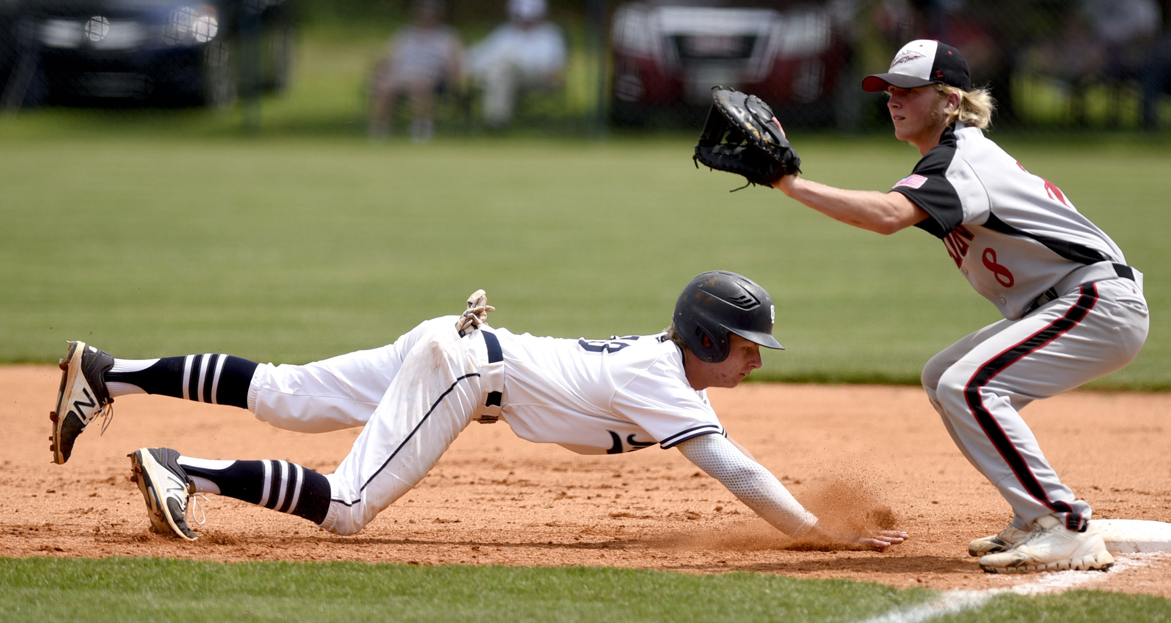 Gordon Lee's Noah Peterson (10) dives back to first to avoid a pick off throw. Charlton County 1st baseman Tyler Beckham (8) awaits the throw. The Charlton County Indians visited the Gordon Lee Trojans in the Georgia State Baseball Tournament Semifinals on May 17, 2017.