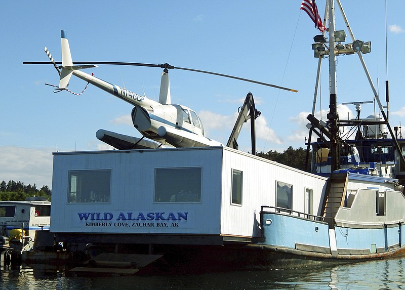 
              FILE - This 2014 file photo, shows the Wild Alaskan, a converted crabbing boat that had been used as a strip club, moored near downtown Kodiak, Alaska. Its owner, Darren Byler, is resurrecting the controversial strip club on board his boat, billing the enterprise as a nightly protest months after he was sentenced to probation for dumping human waste from the vessel. Byler, who is appealing the case, says he will begin his summer-long "First Amendment Freedom of Assembly" protests, complete with exotic dancers, Thursday May 18, 2017. (Kodiak Daily Mirror via AP, File)
            