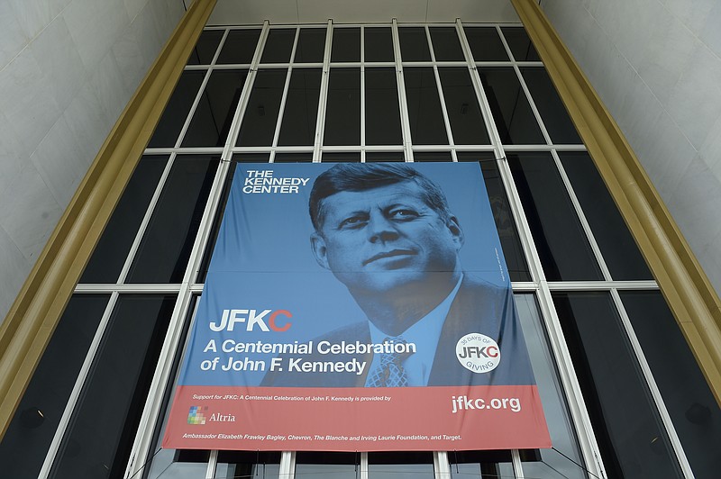 
              A poster hangs outside the Kennedy Center in Washington, Friday, May 5, 2017. This year, in honor of the 100th anniversary of JFK's birth, leaders of the performing arts behemoth are trying to put the Kennedy back into the Kennedy Center, reemphasizing its role as a "living memorial" to the slain 35th president. (AP Photo/Susan Walsh)
            