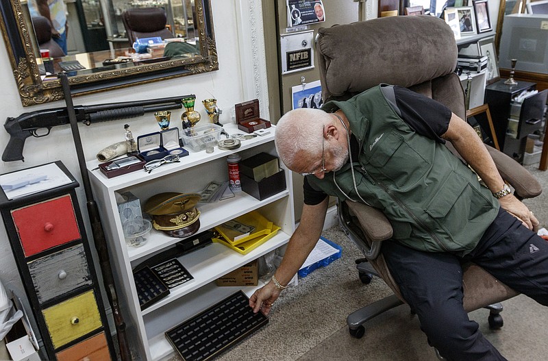 Rick Davis reaches for a jewelry container behind his desk at his Brainerd Road jewelry store, Rick Davis Gold and Diamonds, on Friday, May 5, 2017, in Chattanooga, Tenn. Davis will be on a television show devoted to buying, selling, and evaluating jewelry.