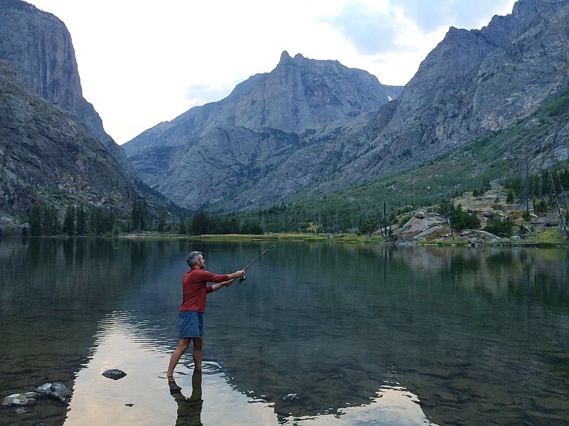 In this Aug. 29, 2016 photo, Mike Eckel tries his hand at trout fishing in Elk Lake, the first of several lakes that drain north along the Beaten Path, a 26-mile hiking trail that crosses through Montana's Absaroka-Beartooth Wilderness. (Ben Yeomans via AP)