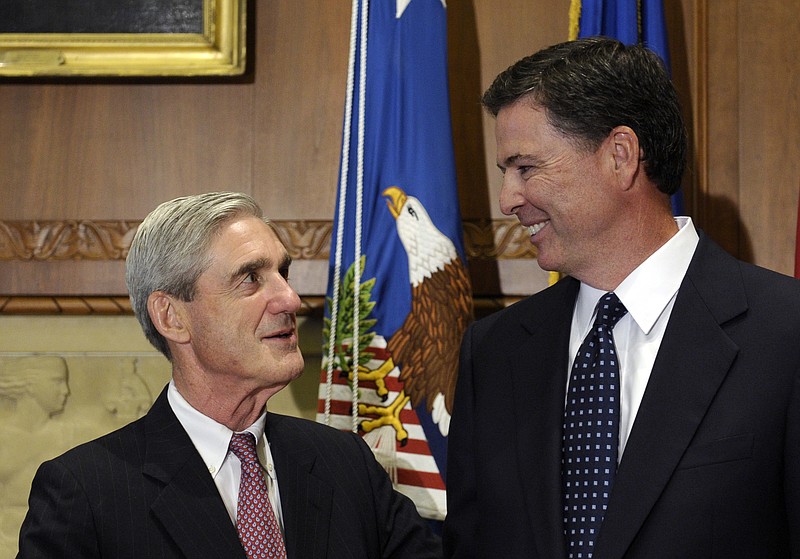 Then-incoming FBI Director James Comey, right, talks with outgoing FBI Director Robert Mueller in 2013. Now, Mueller will serve as a special counsel to continue the work Comey was doing on ties between Russians and the 2016 presidential election before being fired by President Donald Trump.