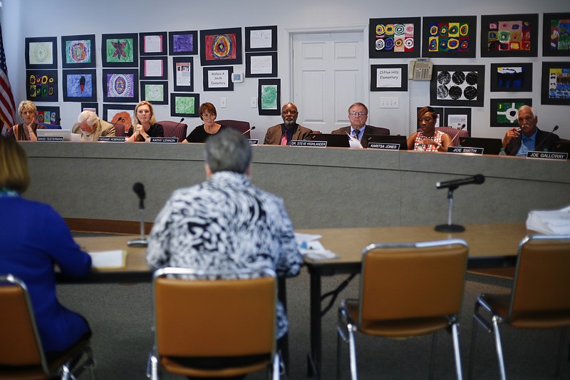 Paintings by area elementary students decorate the walls behind the the Hamilton County Board of Education during a meeting on Thursday, May 18, 2017, in Chattanooga, Tenn. McQueen presented a partnership school district plan to the board to with the goal of improving Hamilton County's lowest performing schools.