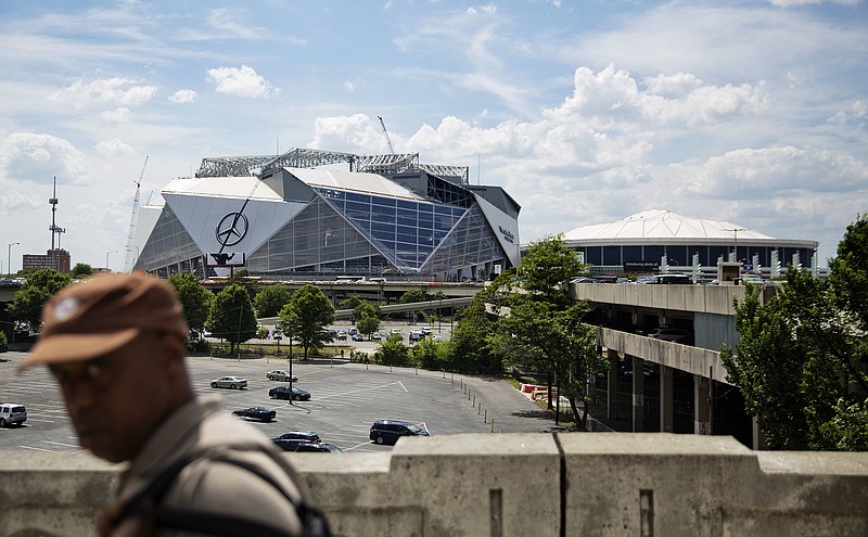 
              Mercedes-Benz Stadium, the new stadium for the Atlanta Falcons NFL football team, sits under construction at left next to the team's current stadium, the Georgia Dome, in Atlanta, Wednesday, May 17, 2017. Several high-profile failures have plagued Atlanta's reputation on a national stage over the years: transportation woes during the 1996 Olympics, unpreparedness for ice and snow storms, a recent highway collapse and subsequent shutdown from a fire. Now, the city's new $1.5 billion stadium, touted as a state-of-the-art facility that can help transform downtown, is facing construction setbacks with its key feature, a retractable roof that will open and close like a camera lens. (AP Photo/David Goldman)
            