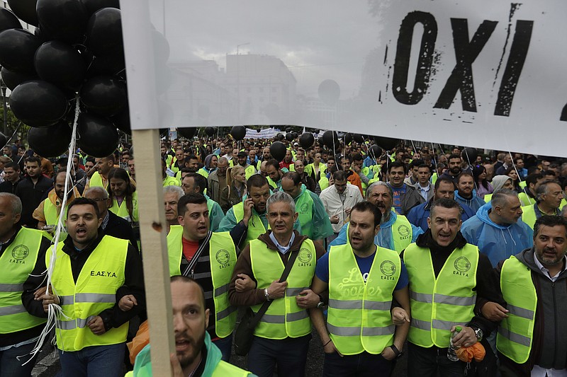 
              Greek police officers chant slogans as they carry a banner which read in Greek "No" during an anti- austerity protest in Athens, Wednesday, May 17, 2017. Greek workers have walked off the job across the country for a nationwide general strike to protest new austerity measures to be imposed beyond the end of Greece's third bailout next year.(AP Photo/Thanassis Stavrakis)
            