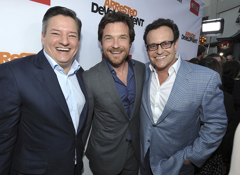 
              FILE - In this April 29, 2013, file photo, Ted Sarandos, Jason Bateman, and Mitchell Hurwitz attend the season four premiere of "Arrested Development" at the TCL Chinese Theatre in Los Angeles. Netflix announced on May 17, 2017, that the series would return for a fifth season in 2018. (Photo by John Shearer/Invision/AP, File)
            