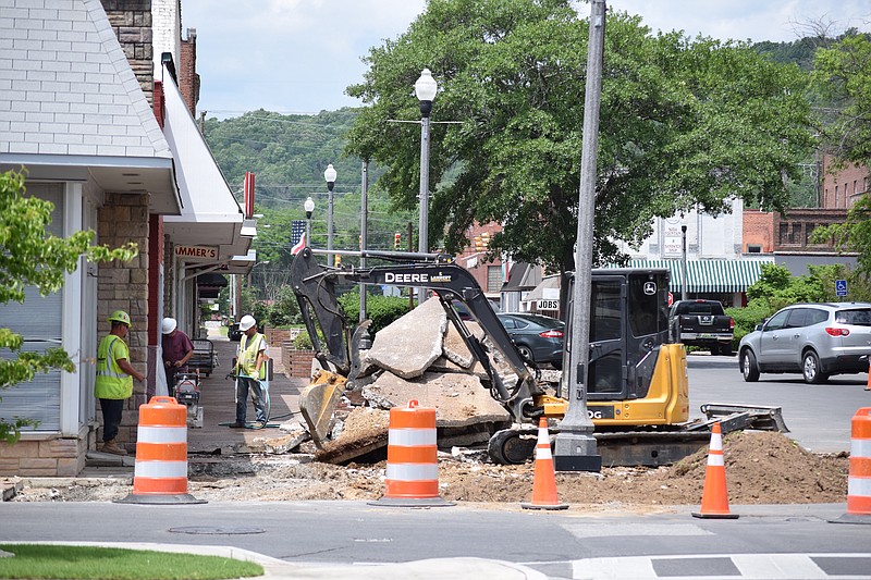 A four-man work crew with Lambert Contracting LLC works to rip up the old concrete sidewalks along the west side of South Broad Street in Scottsboro, Ala., on May 18, 2017. The work is part of a renovation project to replace sidewalks around the Jackson County Courthouse Square.

