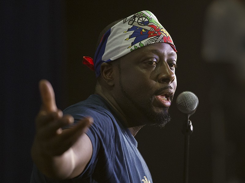 
              In this, Friday, May 19, 2017 photo, Haitian-American hip-hop star Wyclef Jean gestures as he speaks during a news conference at the Little Haiti Cultural Center in Miami. Jean performs Friday in Miami's Little Haiti, a community worried that the Trump Administration won't renew post-earthquake immigration benefits for roughly 50,000 Haitians. (AP Photo/Wilfredo Lee)
            