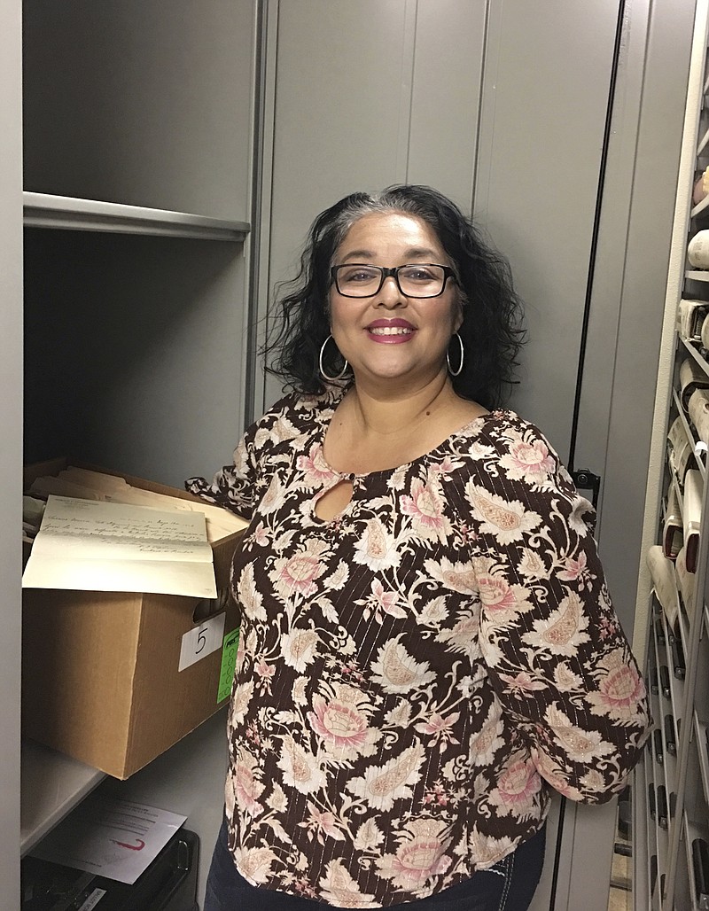 
              In this photo provided by the Doña Ana County Manager's Office, Records and Filing Supervisor Angelica Valenzuela poses at the Doña Ana County Clerk's Office Friday, May 19, 2017, in Las Cruces, N.M. Valenzuela found a century-old document inside a box of unarchived records that sheds light on the death of the Old West lawman Pat Garrett who gained fame for killing Billy the Kid. (Doña Ana County Manager's Office via AP)
            