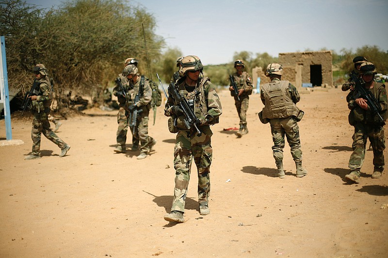 
              FILE-- In this photo taken Sunday Feb. 10, 2013, French soldiers secure the area where a suicide bomber exploded at the entrance of Gao, northern Mali. France's new president Emmanuel Macron has chosen for his first official visit outside Europe the West African nation of Mali, a country where multiple extremist groups pose a growing danger to the region.(AP Photo/Jerome Delay, File)
            