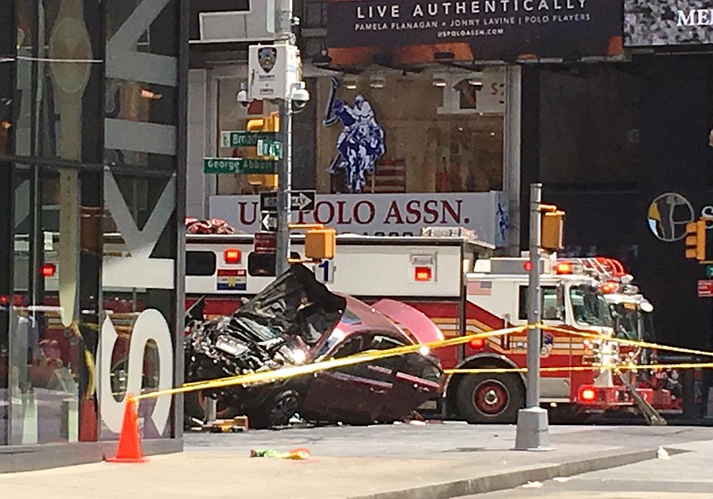 
              A smashed car sits on the corner of Broadway and 45th Street in New York's Times Square after driving through a crowd of pedestrians Thursday, May 18, 2017. (AP Photo/Seth Wenig)
            