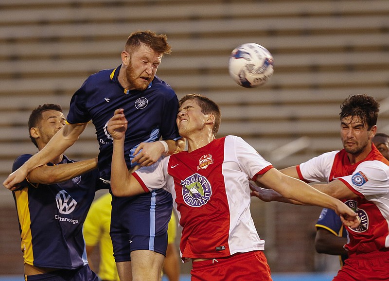 CFC's Carl Reynolds, center left, heads the ball for a shot on the goal during Chattanooga FC's home opener against the Birmingham Hammers at Finley Stadium on Saturday, May 20, 2017, in Chattanooga, Tenn.