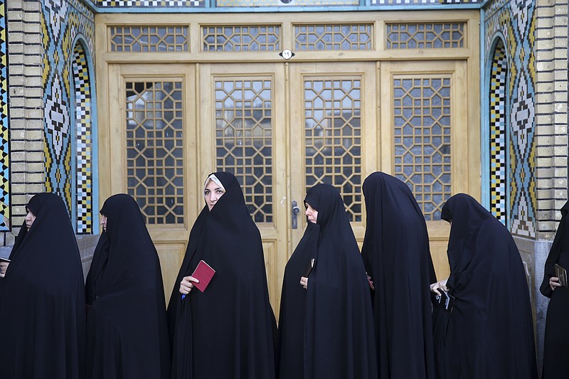 
              Female voters queue at a polling station for the presidential and municipal council election in the city of Qom, 78 miles (125 kilometers) south of the capital Tehran, Iran, Friday, May 19, 2017. Iranians began voting Friday in the country's first presidential election since its nuclear deal with world powers, as incumbent Hassan Rouhani faced a staunch challenge from a hard-line opponent over his outreach to the wider world. (AP Photo/Ebrahim Noroozi)
            