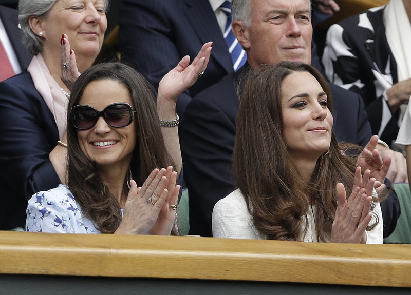 
              FILE - In this Sunday, July 8, 2012 file photo, Kate, Duchess of Cambridge, right, and her sister Pippa Middleton, left, applaud before the start of the men's singles final between Roger Federer of Switzerland and Andy Murray of Britain at the All England Lawn Tennis Championships at Wimbledon, England. 33-year-old Pippa Middleton is marrying a wealthy financier in the village of Englefield, west of London on Saturday May 20, 2017, with a guest list of young A-list royals and reality TV stars looking on. (AP Photo/Kirsty Wigglesworth, File)
            