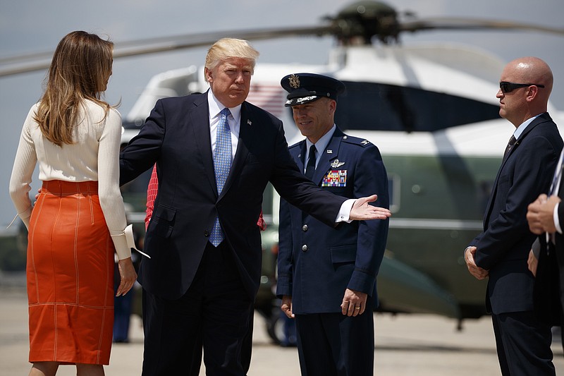 
              President Donald Trump and first lady Melania Trump with Col. Casey D. Eaton, Commander, 89th Airlift Wing, Andrews Air Force Base prepares to board Air Force One at Andrews Air Force Base, Md., Friday, May 19, 2017, for his first international trip as president (AP Photo/Evan Vucci)
            