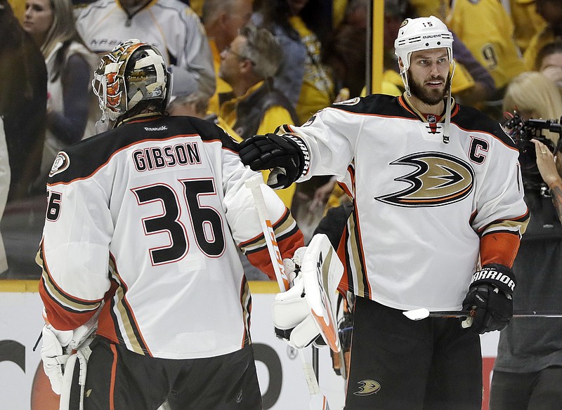 
              Anaheim Ducks center Ryan Getzlaf (15) congratulates goalie John Gibson (36) after the Ducks beat the Nashville Predators in overtime in Game 4 of the Western Conference final in the NHL hockey Stanley Cup playoffs Thursday, May 18, 2017, in Nashville, Tenn. The Ducks won 3-2 to even the series 2-2. (AP Photo/Mark Humphrey)
            