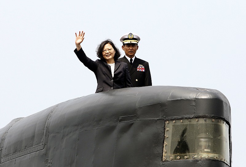 
              FILE - In this Tuesday, March 21, 2017, file photo, Taiwan's President Tsai Ing-wen, left, waves from a Zwaardvis-class submarine during a visit at Zuoying Naval base in Kaohsiung, southern Taiwan. After a year in office, Tsai's administration is shunned by an angry China, but domestic concerns appear to be trumping relations with Beijing. (AP Photo/ Chiang Ying-ying, File)
            