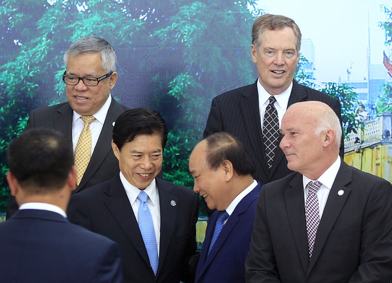 
              Vietnamese Prime Minister Nguyen Xuan Phuc, center right, shakes hands with Chinese Minister of Commerce Zhong Shan, center left, as Philippine Trade Secretary Ramon Lopez, top left,  U.S Trade Representative Robert Lighthizer, top right, and Peruvian Trade Minister Eduardo Ferreyros, bottom right, look on after a group photo at the Asia-Pacific Economic Cooperation (APEC) Trade ministerial meeting in Hanoi, Vietnam on Saturday, May 20, 2017. The Pacific Rim trade ministers started their two-day meeting in Hanoi focusing on free trade and regional economic integration amid fears of growing trade protectionism. (AP Photo/Hau Dinh)
            