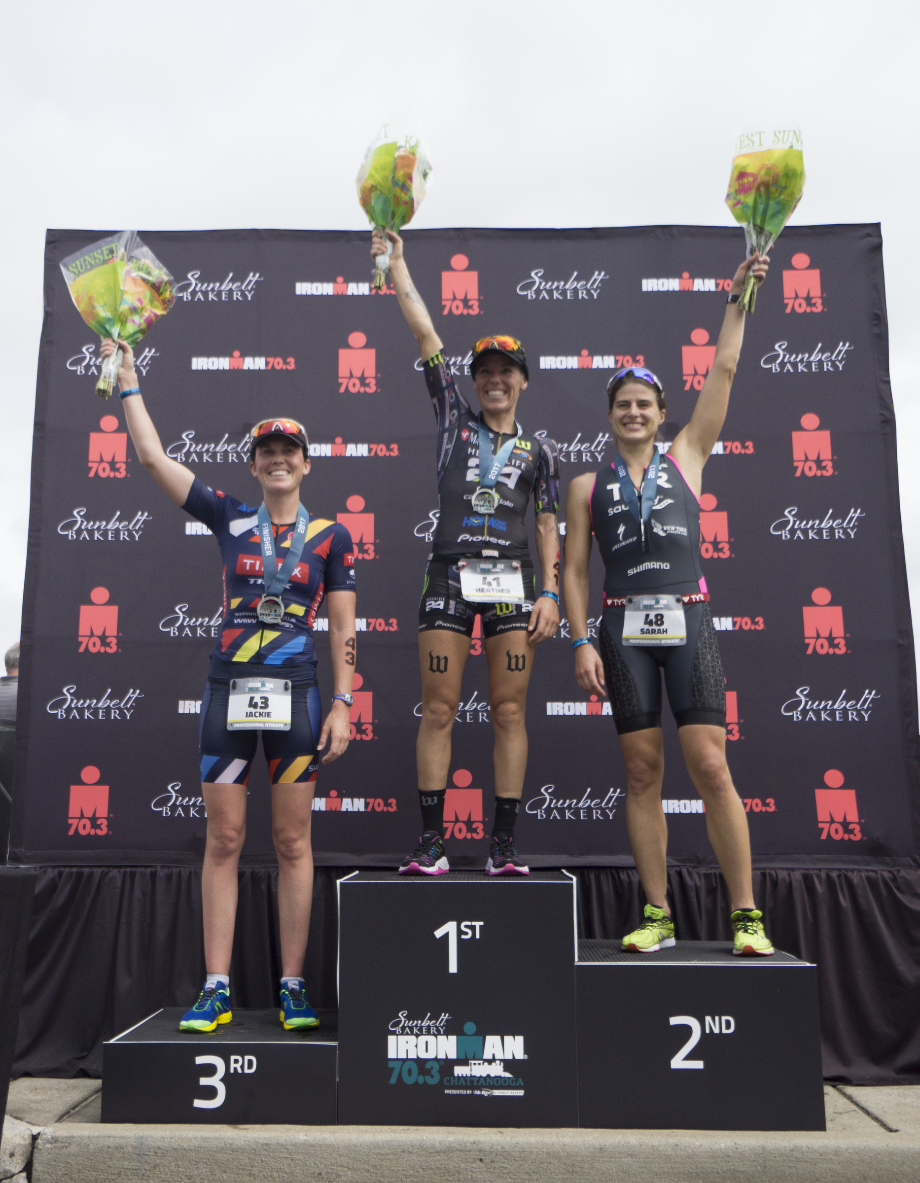 Heather Jackson, first place, Sarah True, second place, and Jackie Hering, third place, celebrate their podium during the Sunbelt Bakery IRONMAN 70.3 Chattanooga triathlon presented by McKee A Family Bakery in downtown Chattanooga on Sunday, May 21, 2017. Photo by Dan Henry | DanHenryPhotography.com