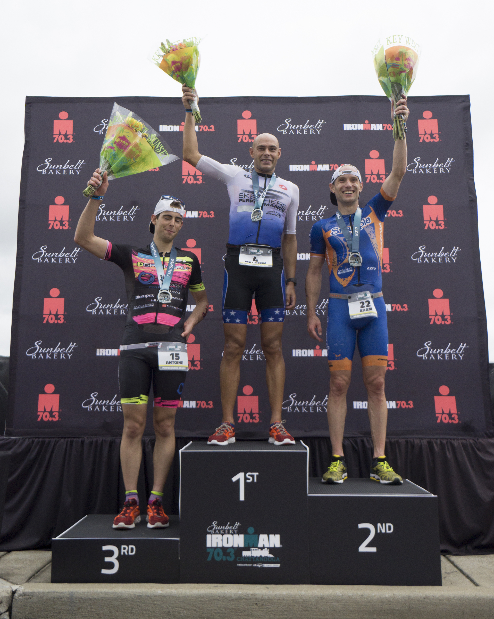 Matthew Russell, first place, Adam Otstot, second place, and Antoine Jolicoeur Desroches celebrate their podium during the 2017 Sunbelt Bakery IRONMAN 70.3 Chattanooga triathlon presented by McKee A Family Bakery in downtown Chattanooga on Sunday, May 21, 2017. Photo by Dan Henry | DanHenryPhotography.com