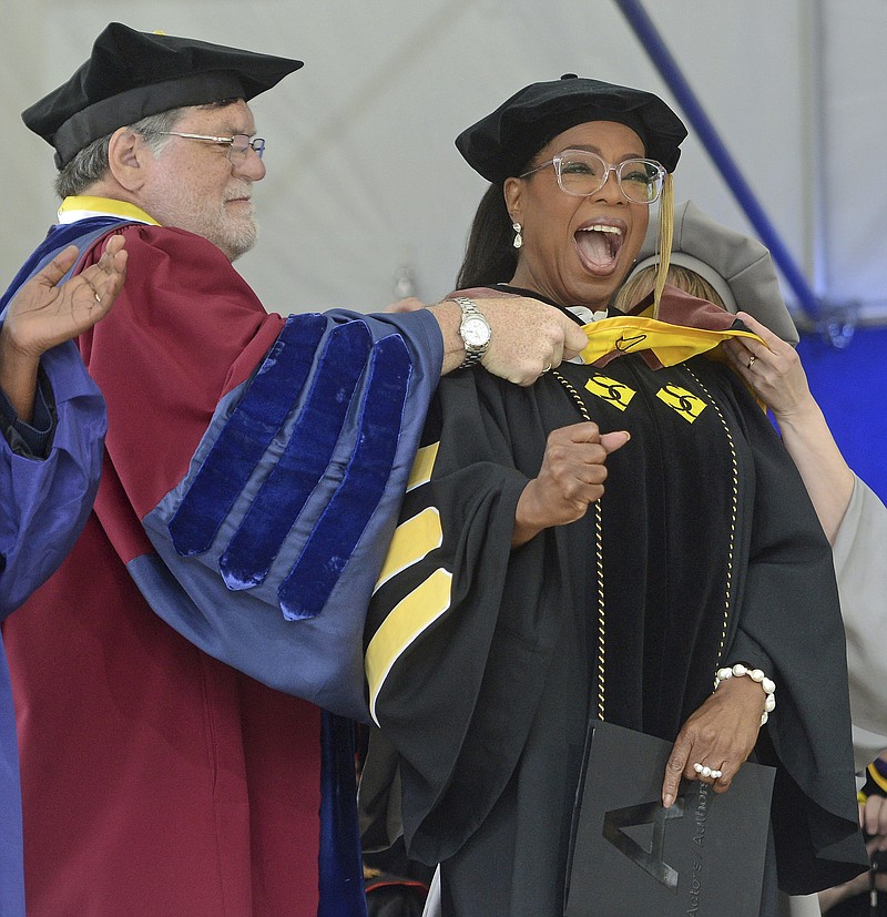 
              Bill E. Peterson, Associate Provost and Dean of Academic Development, left,  presents Oprah Winfrey with an honorary degree during Smith College's 139th Commencement ceremony on Sunday, May 21, 2017 in Northampton, Mass. The author, actress, philanthropist and former talk show host gave the college's commencement address. (David Molnar/Springfield Republican via AP)
            