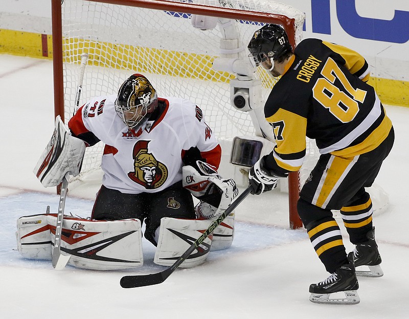 
              Pittsburgh Penguins' Sidney Crosby (87) scores on Ottawa Senators goalie Craig Anderson (41) during the first period of Game 5 in the NHL hockey Stanley Cup Eastern Conference finals, Sunday, May 21, 2017, in Pittsburgh. (AP Photo/Gene J.Puskar)
            