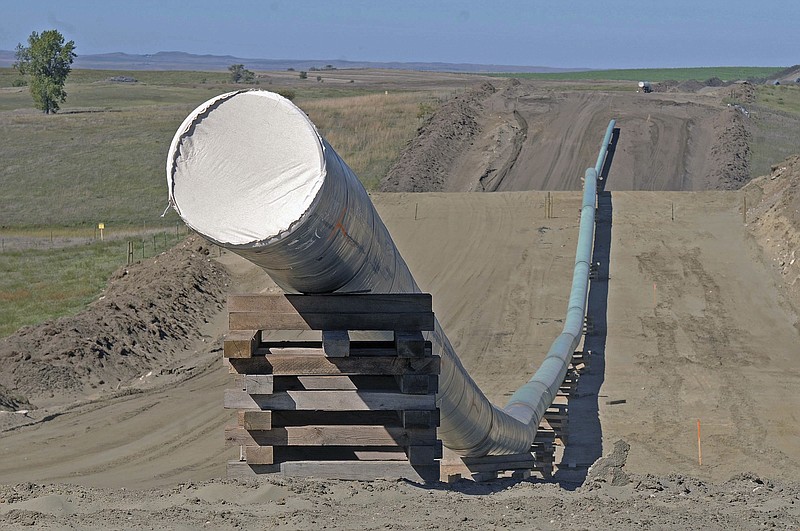 
              FILE - This Sept. 29, 2016, file photo, shows a section of the Dakota Access pipeline under construction near St. Anthony in Morton County, N.D. The Dakota Access pipeline system leaked about 100 gallons of oil in western North Dakota in two separate incidents in March as crews worked to get the four-state line ready for operation. They’re the second and third known leaks on the disputed $3.8 billion pipeline.  (Tom Stromme/The Bismarck Tribune via AP, File)
            