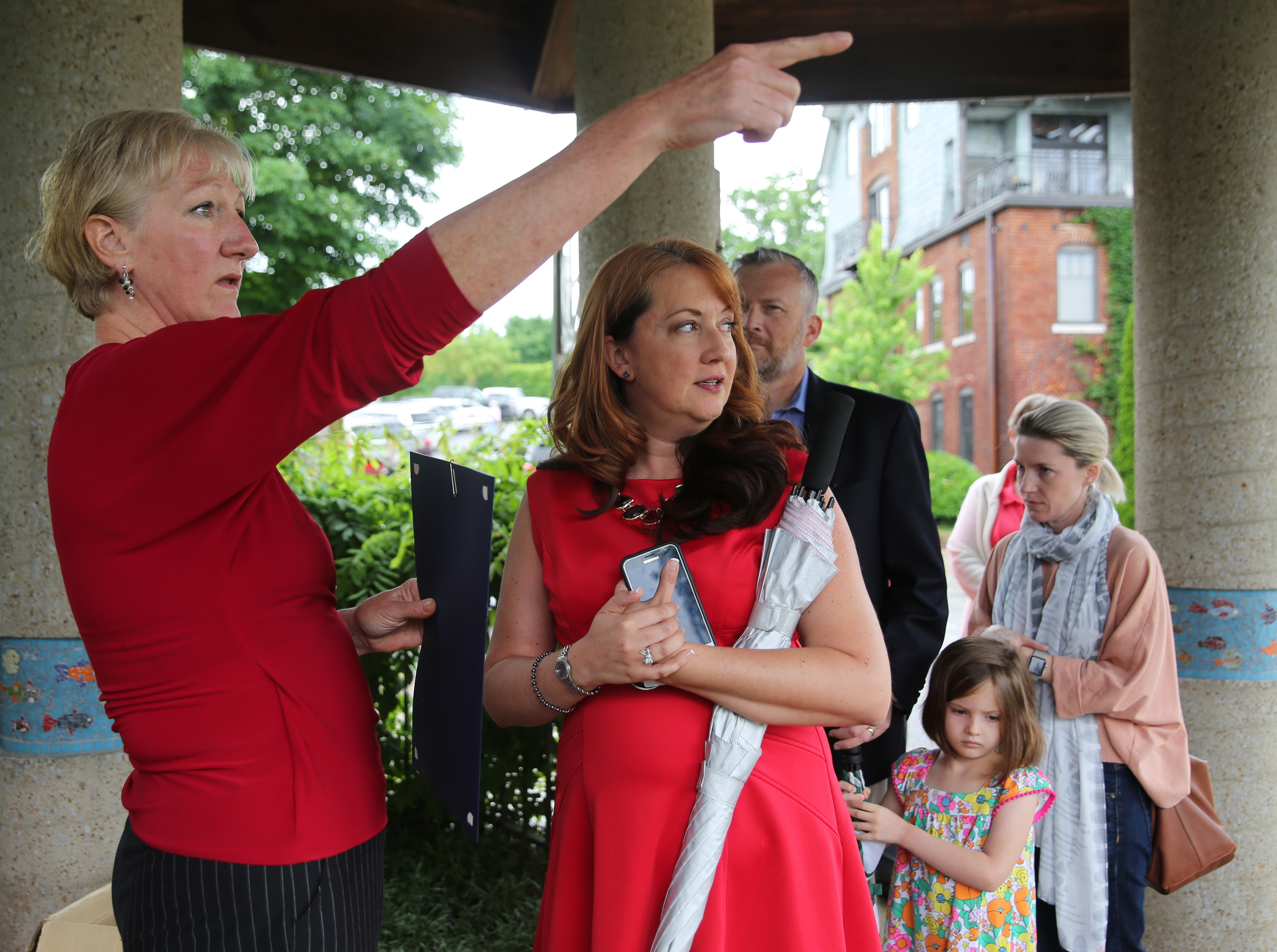 Caroline Johnson, program coordinator, points out where different flags are located for each honoree to Natalie Blackwell during the Veterans Bridge Flag Raising Ceremony held to honor service men and women Mon., May 22, 2017, at the Bluff View Art District Sculpture Garden in Chattanooga, Tenn. Blackwell attended the event to receive a proclamation on behalf of her husband, who is a Hamilton County paramedic.