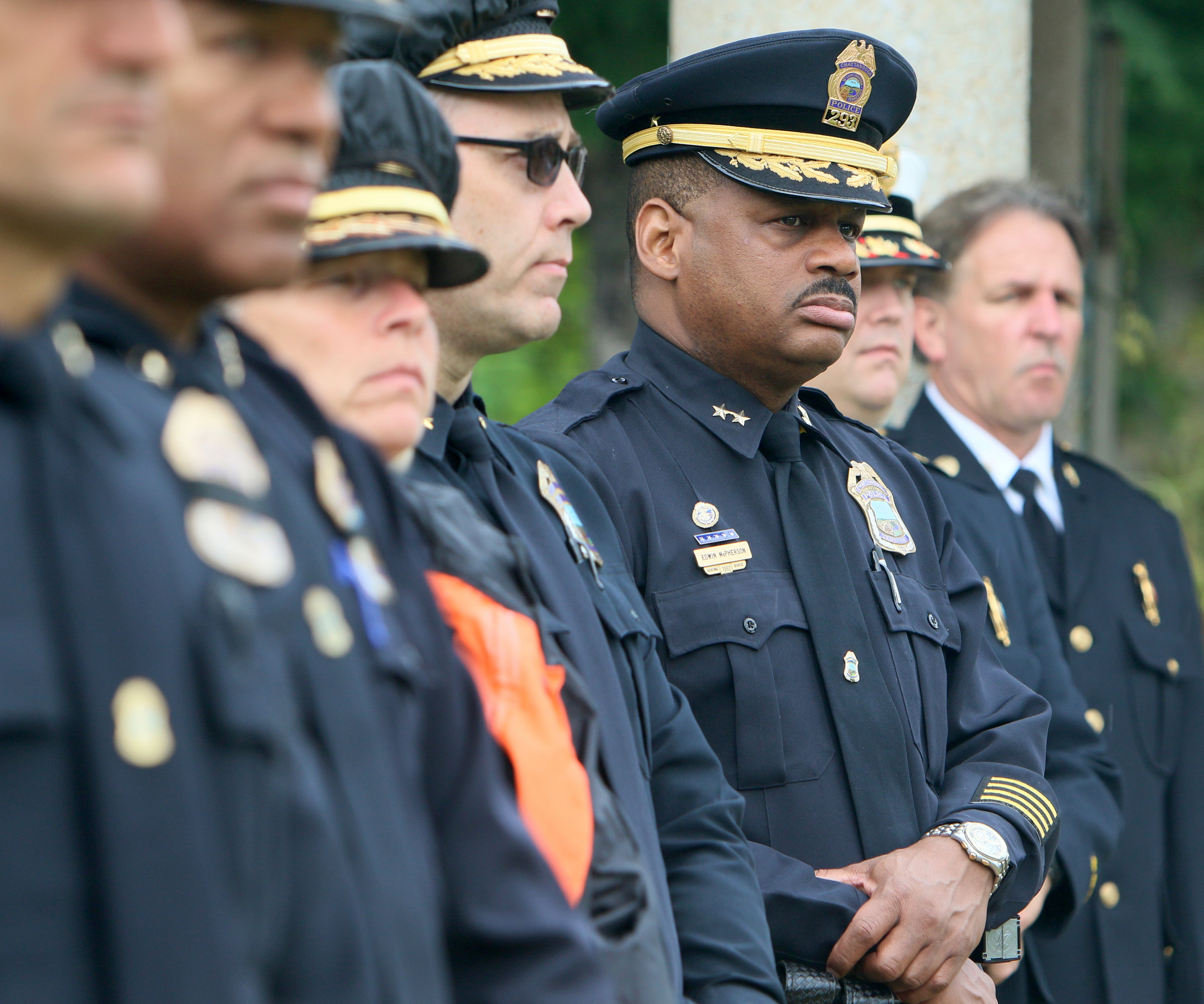 Assistant Chief of Criminal Investigations Edwin McPherson stands with other Chattanooga Police Department personnel during the Veterans Bridge Flag Raising Ceremony held to honor service men and women Mon., May 22, 2017, at the Bluff View Art District Sculpture Garden in Chattanooga, Tenn. Flags stay up for six months are are switched twice a year around Veterans Day and Armed Forces Day.