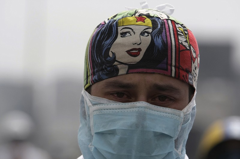 
              A medical professional wears his scrubs during an anti-government protest demanding Venezuelan President Nicolas Maduro open a so-called humanitarian corridor for the delivery of medicine and food aid, in Caracas, Venezuela, Monday, May 22, 2017. At least 46 people have died during the two-month anti-government protest movement. (AP Photo/Fernando Llano)
            