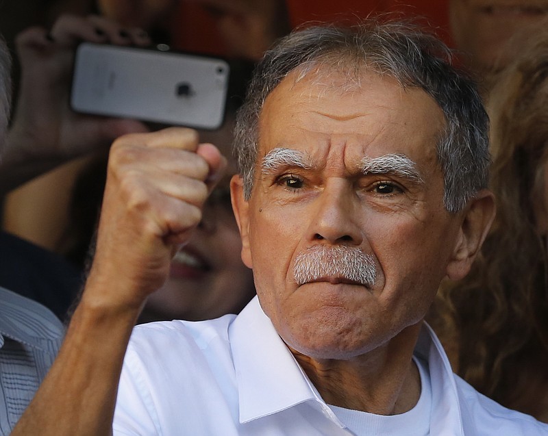 
              Puerto Rican nationalist Oscar Lopez Rivera reacts to the crowd at a gathering in his honor in Chicago's Humboldt Park neighborhood, Thursday, May 18, 2017. Lopez, who was freed from house arrest this week after decades in prison was honored with a parade and a street-way named after him as relatives of those killed in FALN bombings in the '70s and 80's have criticized the moves to honor Lopez and cast him as a hero. (AP Photo/Charles Rex Arbogast)
            