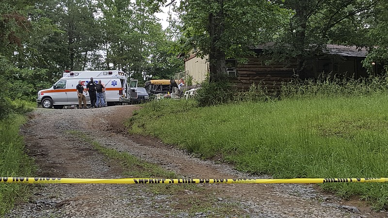 Ambulance personnel and McMinn County Sheriff's Office investigators are shown on the scene of a shooting on County Road 82 in Riceville, Tenn., on Monday. Authorities said Christopher Mackey of Arkansas was shot at least once at the residence of Paul Brent Burgess during an altercation at Burgess' home.