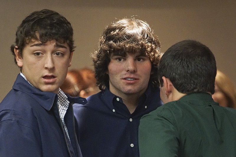 Avery Johnson, Fields Chapman, and Andrew Haynes, from left, converse during a break while in Gilmer County Superior Court Judge Amanda H. Mercier's courtroom on October 23, 2014. The three are defendants in a sexual battery case from a Calhoun High School's post prom party earlier this year. On July 7, a Gilmer County grand jury indicted 18-year-old Andrew Isaac Haynes on a count of sodomy, based on evidence that Haynes performed oral sex against the will of a female student during a post-prom party. The grand jury also indicted 18-year-olds Fields Benjamin Chapman and Damon Avery Johnson on other charges in the case.