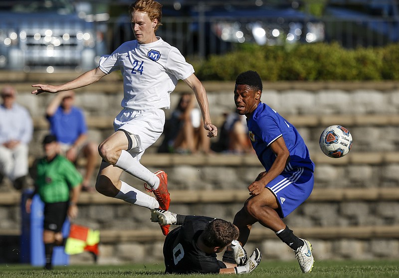 McCallie player Philip Martin (24) leaps over teammate and goalkeeper Emerson Brock as Boyd-Buchanan player Jeremy Borders collides with Brock during their soccer match at McCallie School on Tuesday, May 2, 2017, in Chattanooga, Tenn.