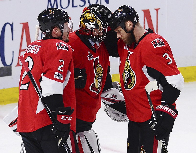 
              Ottawa Senators defenseman Dion Phaneuf (2), Senators goalie Craig Anderson (41) and Ottawa Senators defenseman Marc Methot (3) celebrate after defeating the Pittsburgh Penguins in game six of the Eastern Conference final in the NHL Stanley Cup hockey playoffs in Ottawa on Tuesday, May 23, 2017. (Sean Kilpatrick/The Canadian Press via AP)
            