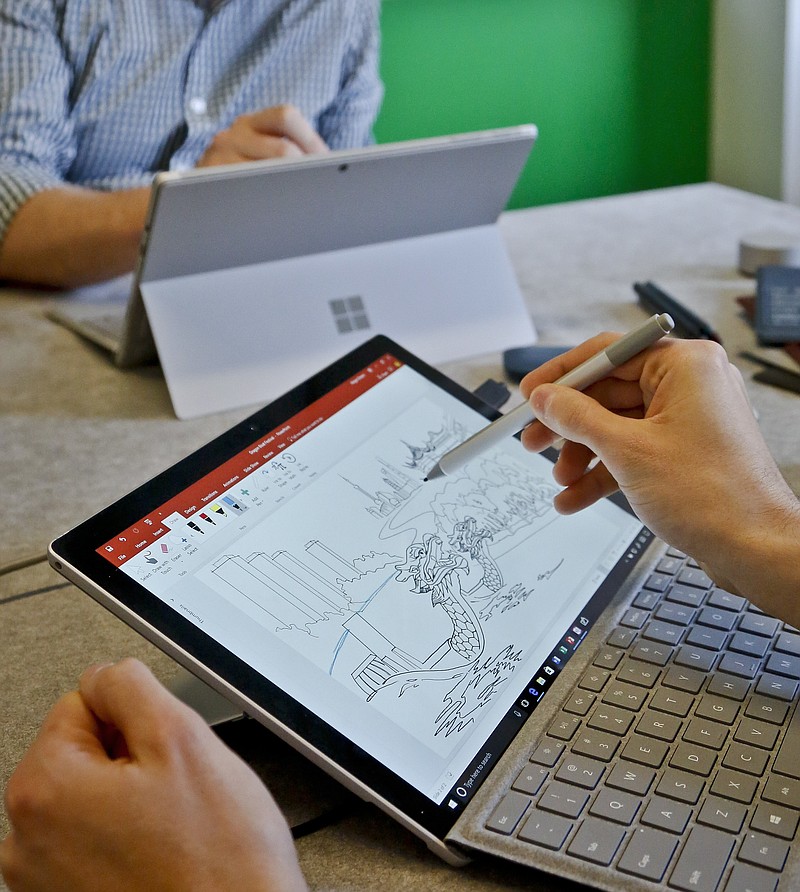 
              In this Tuesday, May 16, 2017, photo, Microsoft's new Surface Pro laptop-tablet hybrid is displayed, in New York. The Surface’s stylus will now mimic pencil shading when tilted, much like the Apple Pencil for iPad Pro tablets. Along with this, Microsoft plans upgrades to its popular Office software with new pencil-like features. (AP Photo/Bebeto Matthews)
            