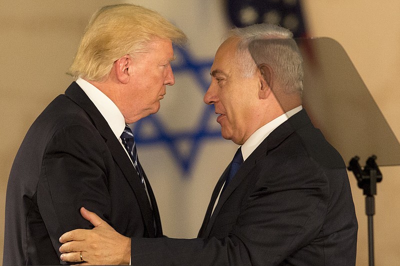 
              US President Donald Trump and Israeli Prime Minister Benjamin Netanyahu embrace at the Israel museum in Jerusalem, Tuesday, May 23, 2017. President Donald Trump on Tuesday pushed for elusive peace between Israel and the Palestinians, calling on both sides to put aside the "pain and disagreements of the past." (AP Photo/Sebastian Scheiner)
            