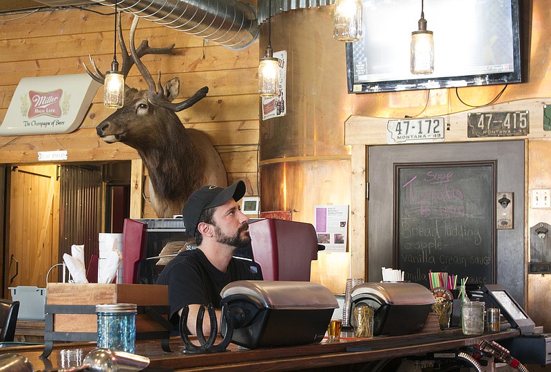 
              In this Thursday, May 18, 2017 photo, Adam Maleski waits to begin his shift in the kitchen a tavern in White Sulfur Springs, Mont. Maleski hasn't decided whether he will cast a ballot in the May 25 special election to fill Montana's vacant U.S. House seat. He has no health insurance, he said, because he can't afford it. He is still paying off thousands in dollars in medical bills after he rolled his car nearly two years ago. He was not insured at the time of the accident. (AP Photo/Bobby Caina Calvan)
            