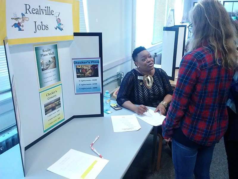 Nicole Brown, a communications professor at the University of Tennessee at Chattanooga was one of the volunteers who recently brought the Chattanooga Chamber of Commerce's financial literacy program, Reality Check, to high school seniors at the Chattanooga School for the Arts & Sciences