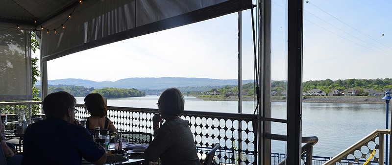 Boathouse diners enjoy the view from the deck.