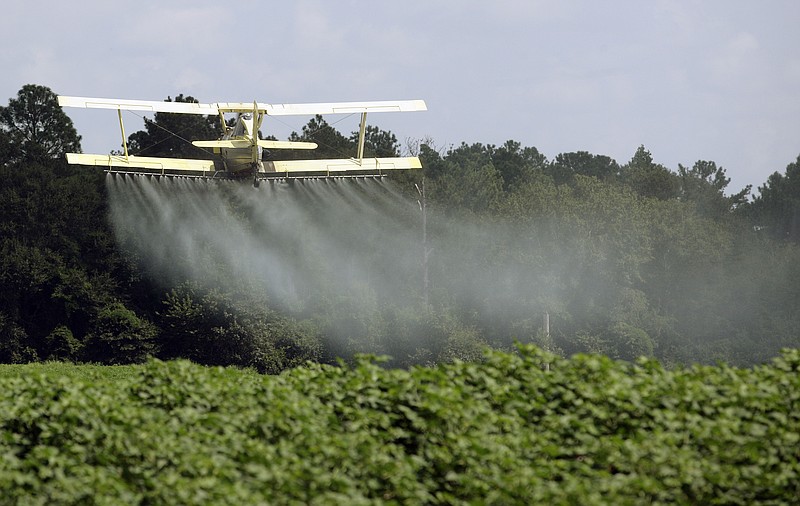 
              FILE - In this Aug. 4, 2009, file photo, a crop duster sprays a field of crops just outside Headland, Ala. The House passed a Republican-backed measure reversing an Environmental Protection Agency requirement that those spraying pesticides on or near rivers and lakes file for a permit. The chamber voted largely along party lines on May 24, 2017, to approve the Reducing Regulatory Burdens Act. The bill’s sponsors say the rule requiring a permit under the Clean Water Act before spraying pesticides is burdensome and duplicative. EPA already regulates pesticide safety under a different law. (AP Photo/Dave Martin, File)
            