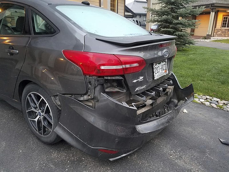 
              This Monday, May 22, 2017, photo shows a damaged delivery vehicle in Steamboat Springs, Colo. A bear damaged the bumper of the car used to deliver doughnuts in Colorado before it tried to claw its way through the trunk to get inside. (Kim Robertson via AP)
            