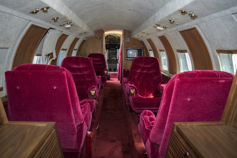 
              This undated photo provided by GWS Auctions, Inc. shows the interior of a private jet once owned by Elvis Presley on a runway in New Mexico.  GWS Auctions Inc. out of California is holding an auction for the plane on May 27, 2017 at an event featuring A-list celebrity memorabilia. The interior was designed by Elvis Presley, with gold-tone, woodwork, inlay and red velvet seats and red shag carpet. However, the plane has no engine and the cockpit has not been restored. (GWS Auctions, Inc. via AP)
            