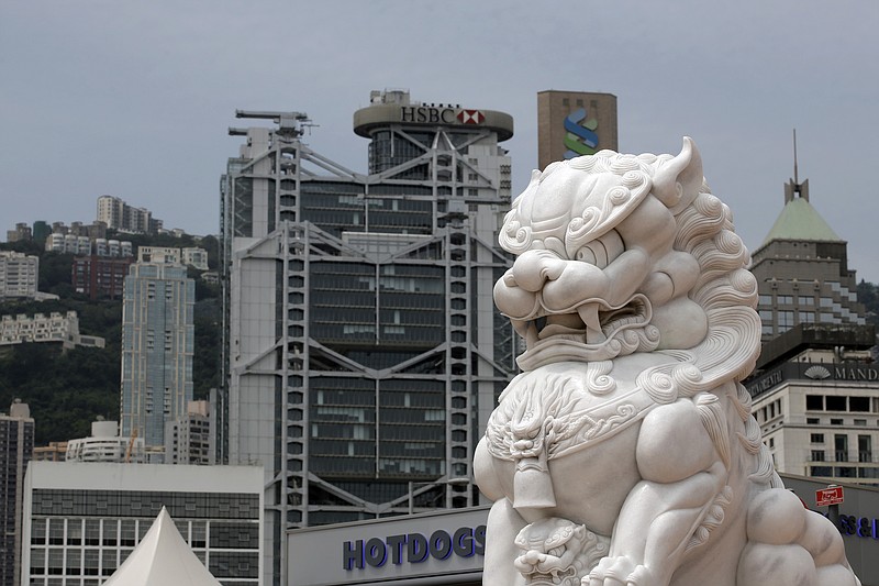 
              A lion statue sits in Hong Kong's business district of Central with financial buildings in rear, Thursday, May 25, 2017. Moody's has cut its credit rating for Hong Kong hours after downgrading China for rising debt levels, which it said would have "significant impact" on the Asian financial hub because of their close links. (AP Photo/Kin Cheung)
            