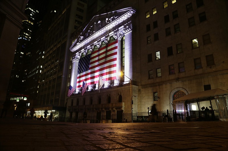 
              FILE - In this Friday, Feb. 17, 2017, file photo, an American flag hangs on the front of the New York Stock Exchange on an evening, in New York. Global stock markets traded in narrow ranges Wednesday, May 24, 2017, with investors brushing aside Moody's decision to cut China's debt rating. (AP Photo/Peter Morgan, File)
            