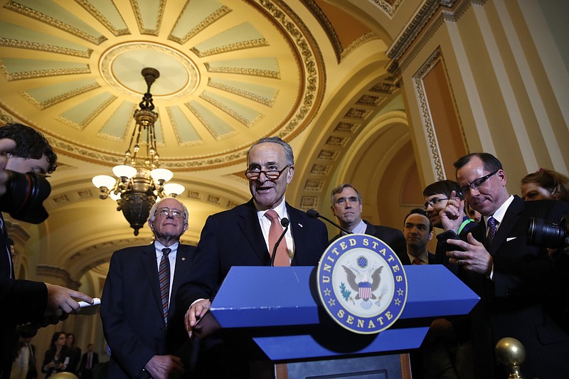 
              Senate Minority Leader Charles Schumer of N.Y., center, flanked by Sen. Bernie Sanders, I-Vt., left, and Sen. Jeff Merkley, D-Ore., meets with reporters on Capitol Hill in Washington, Tuesday, May 23, 2017, following a Democratic policy luncheon. (AP Photo/Jacquelyn Martin)
            
